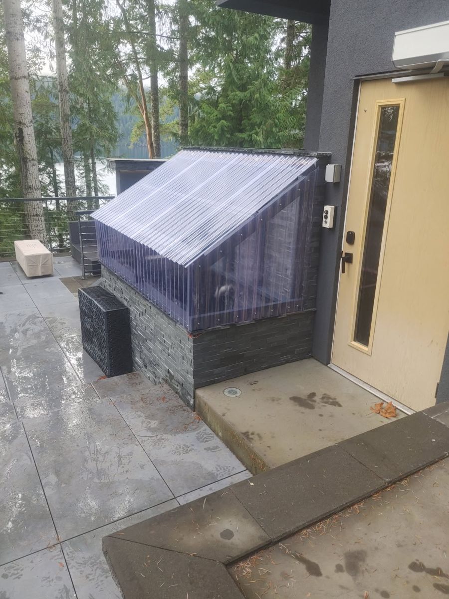 Clear-roofed enclosure with stone base